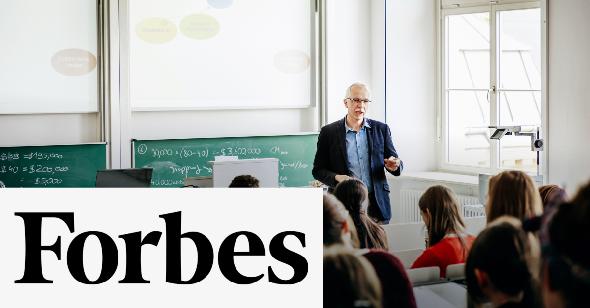 Image of a teacher talking to his students in a classroom. On the lower left corner of the graphic is placed the Forbes logo. 