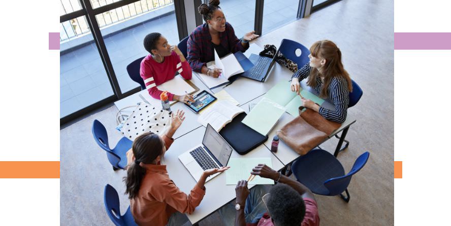 a group of people working together at a table