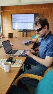 blind man using a braille keyboard