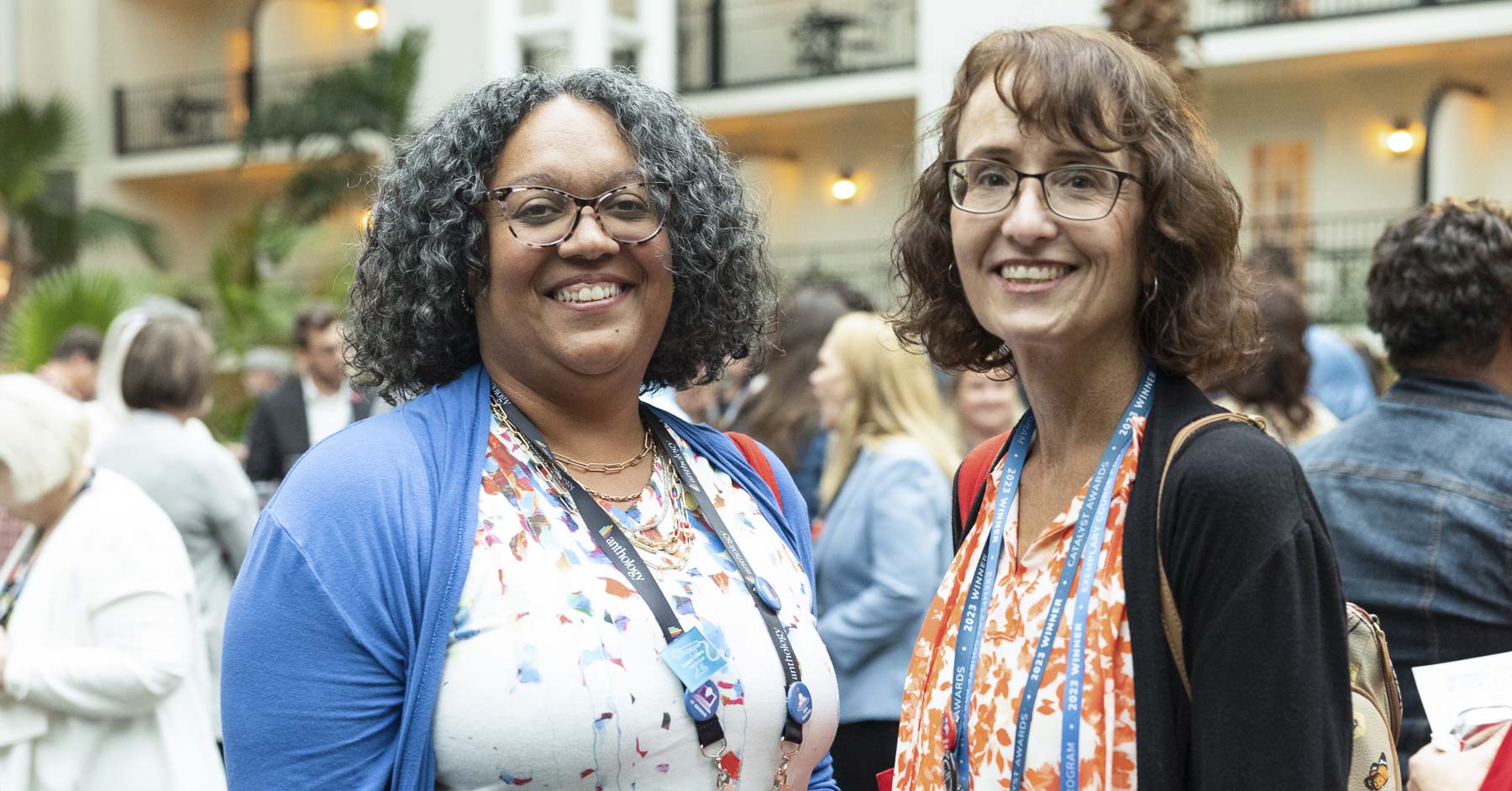 Two attendees smiling for a picture at a networking event