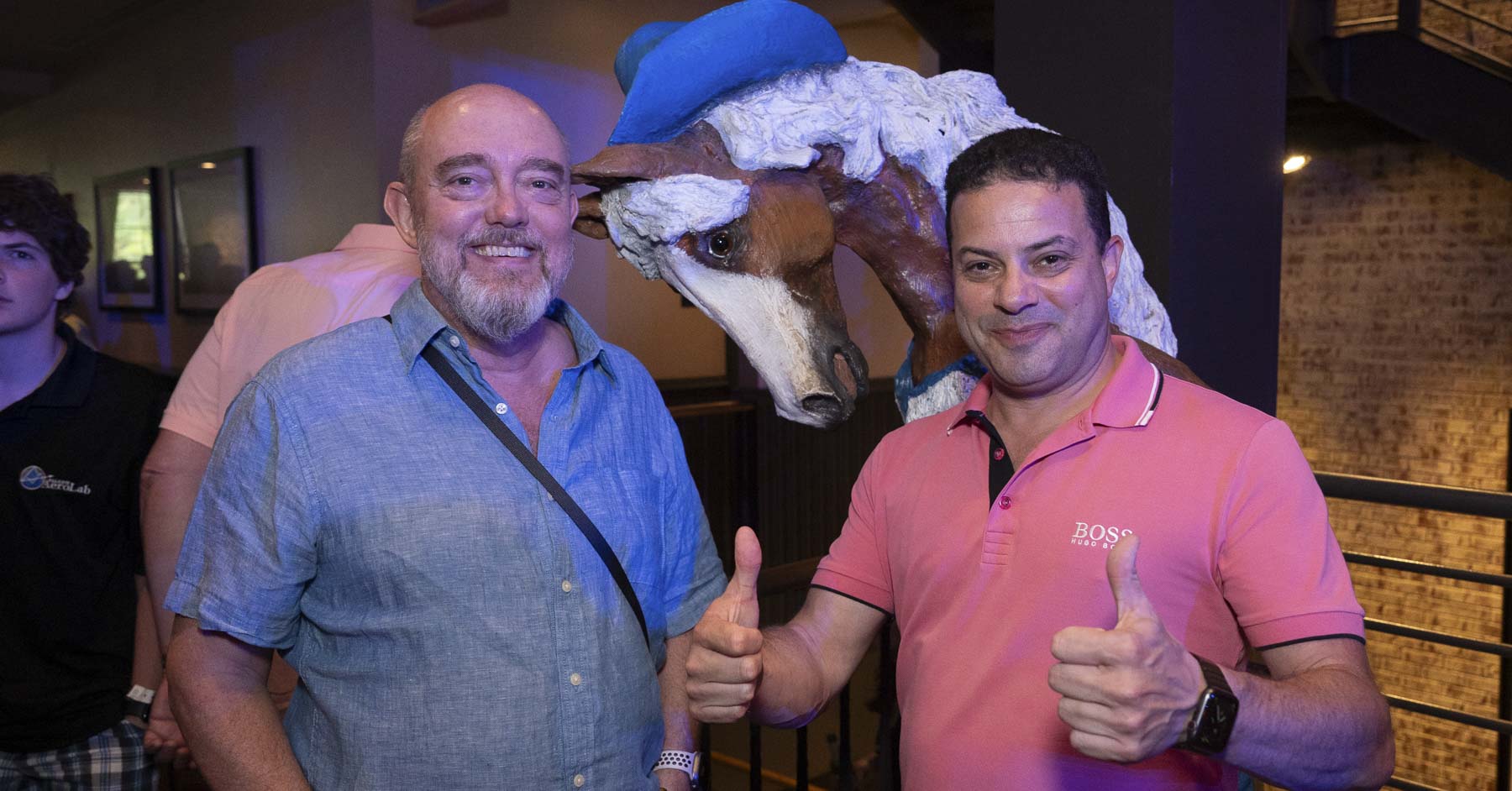 Two attendees smiling for a picture with a Nashville horse statue