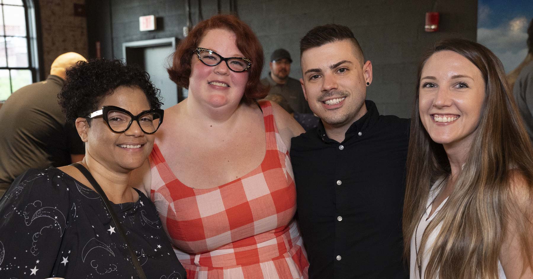 Four attendees smiling for a picture