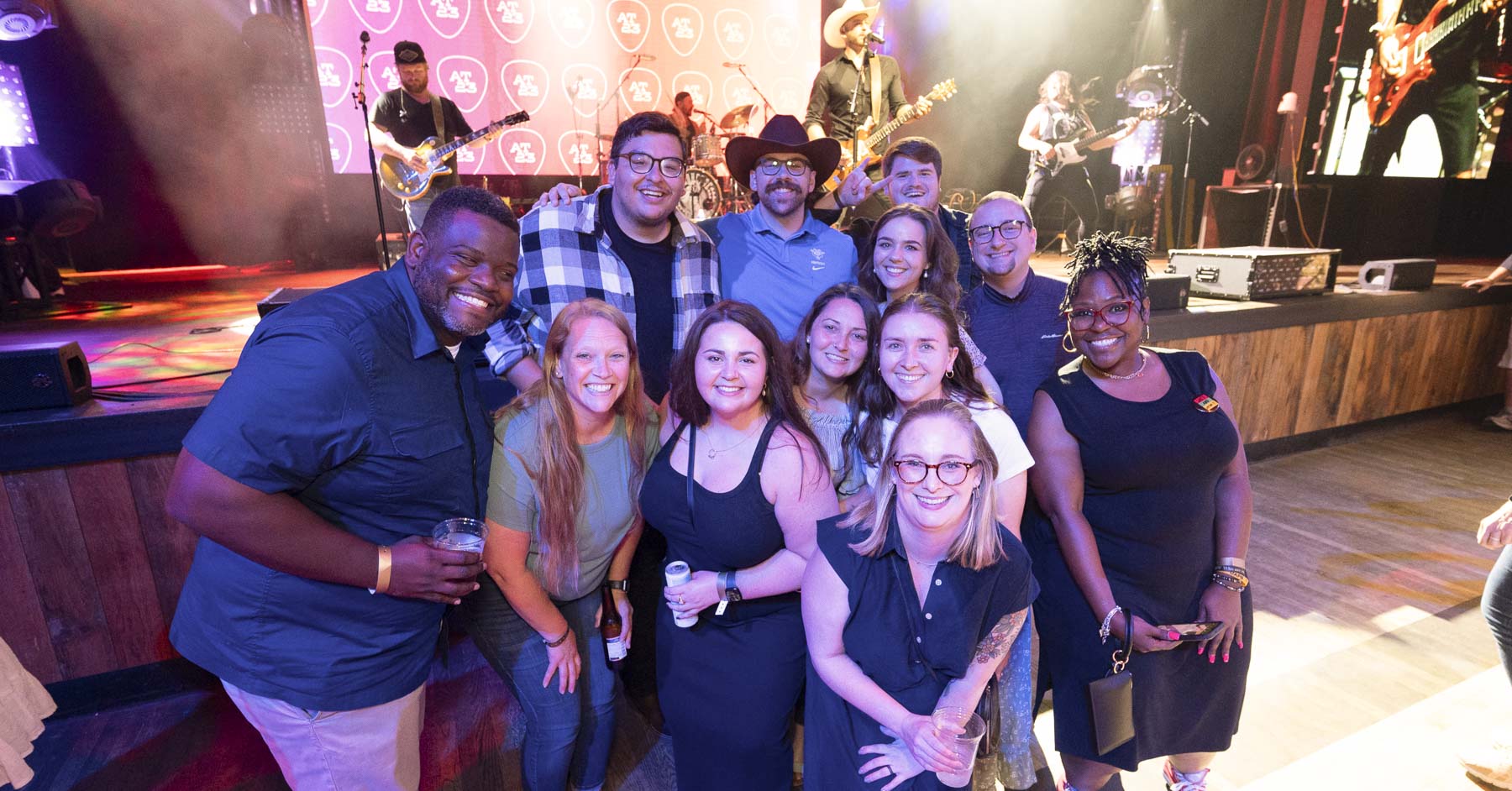 A group of 12 attendees taking a group picture at the downtown event