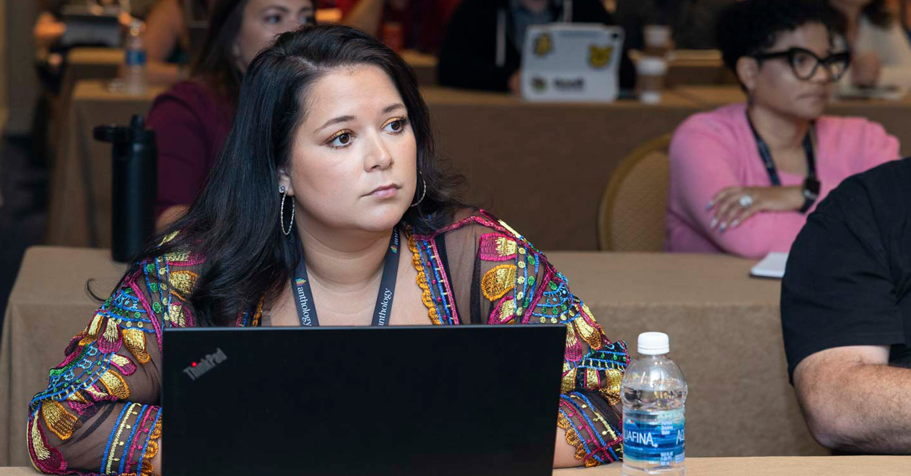 A woman listening to a session with her laptop