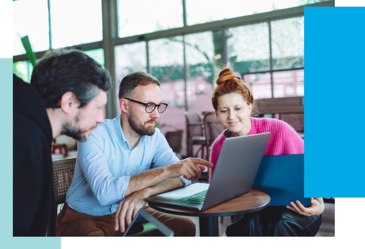 Photo of three people working around a table