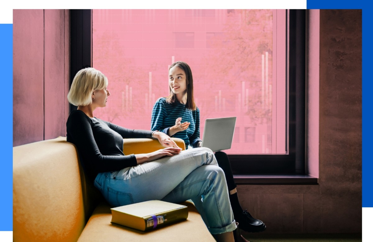 Photo of two people working together in a dorm setting