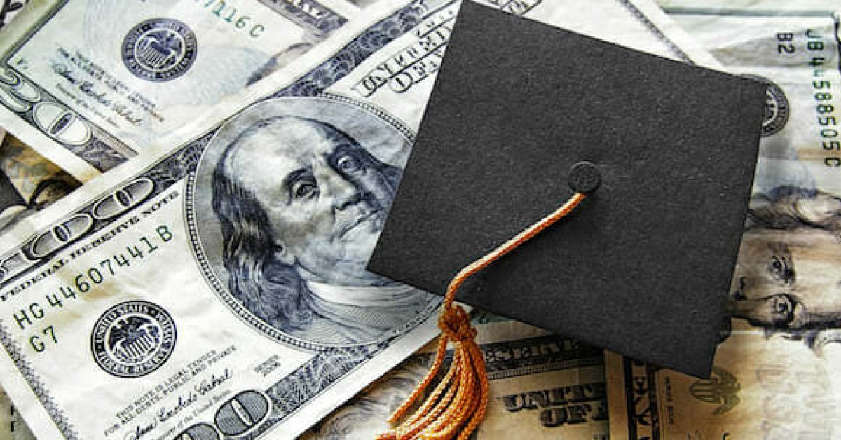 Photo of a graduation cap over US currency