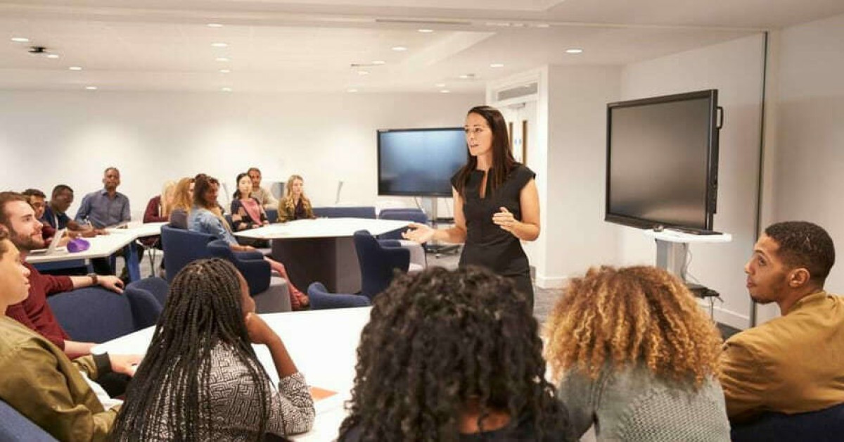 Photo of students and a teacher in a classroom