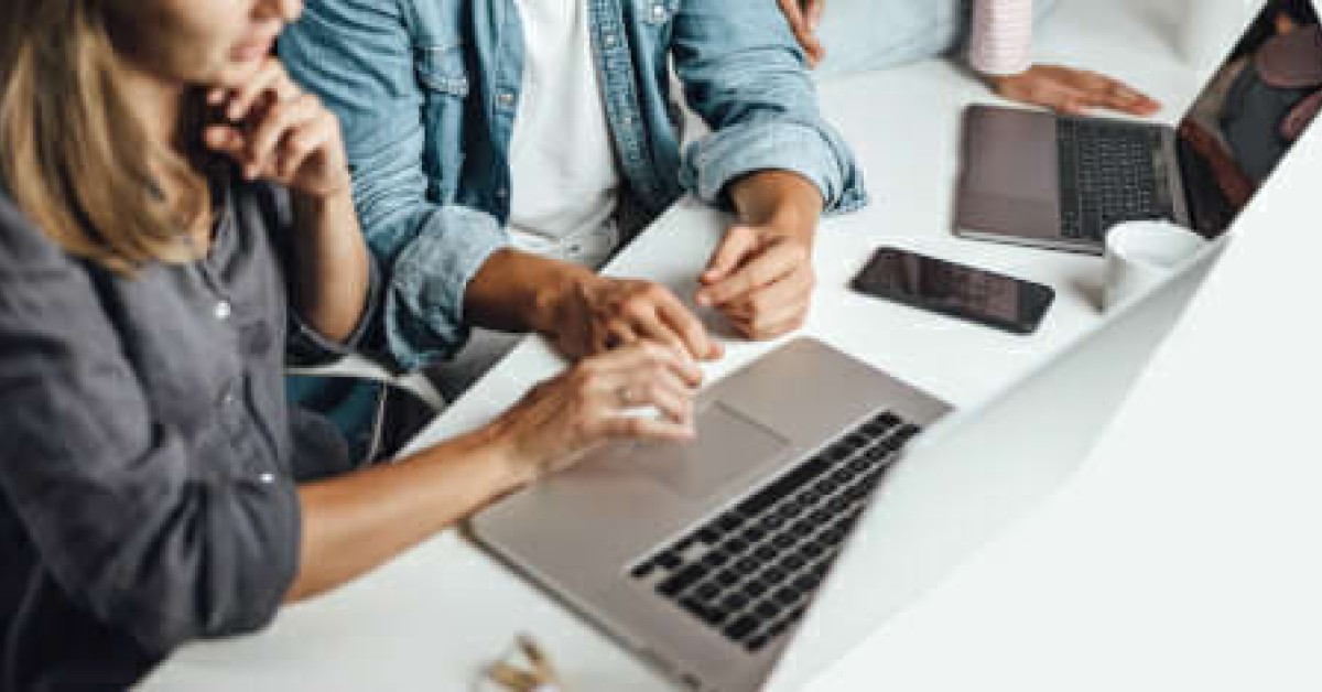 Closer up photo of two people collaborating at a laptop