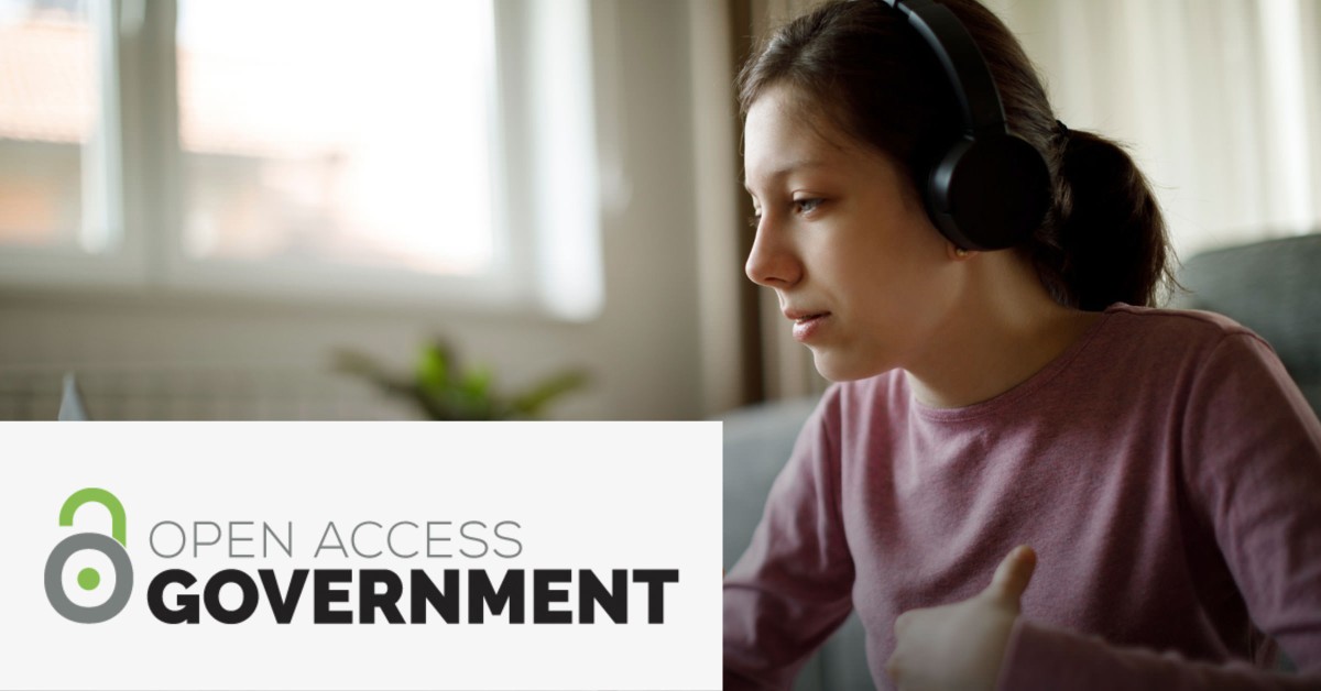 Photo of a woman working while wearing headphones with the Open Access Government overlayed