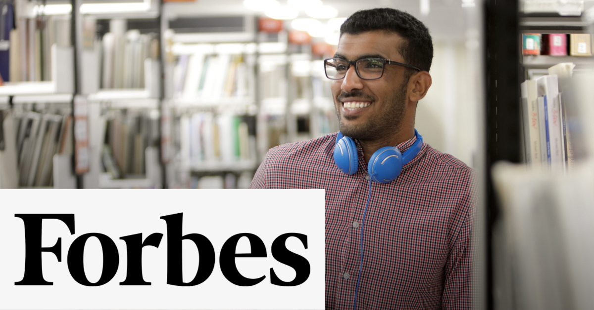 Photo of a student in the library with headphones and the text overlay, Forbes