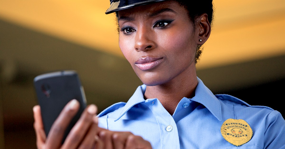 Photo of a female police officer viewing a training course on her phone