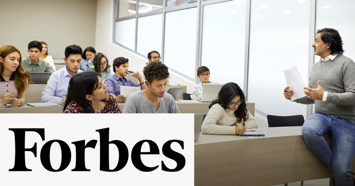 Image of a group of students with a teacher in a classroom,  and a teacher with the Forbes logo placed on the left lower corner. 