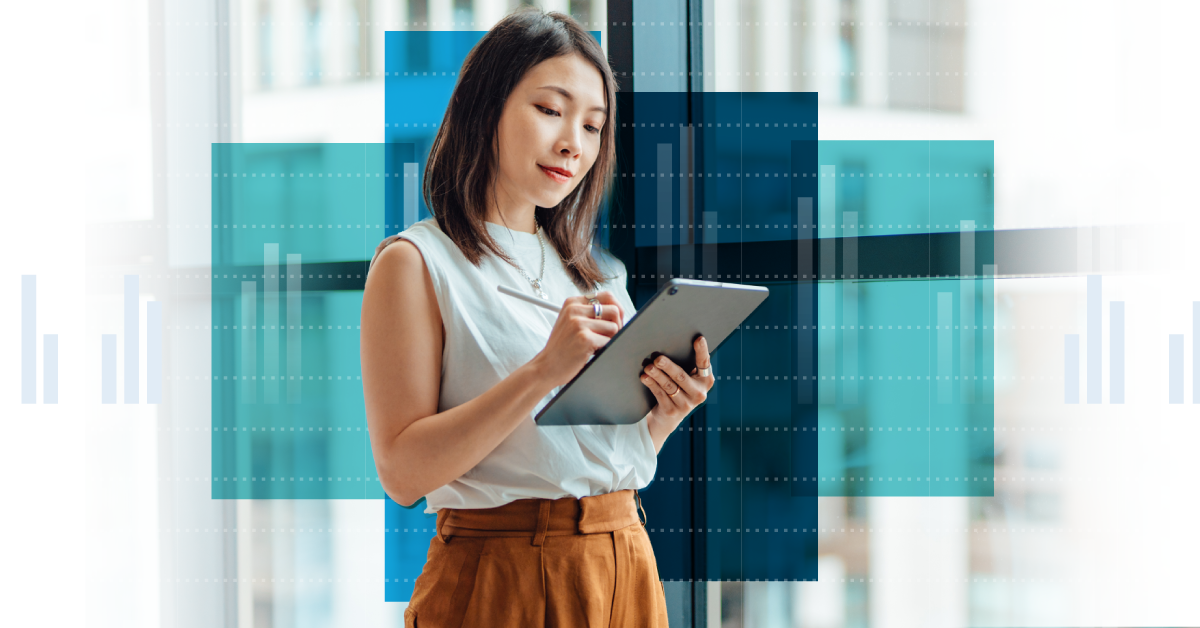 Photo of a woman standing and working on a tablet