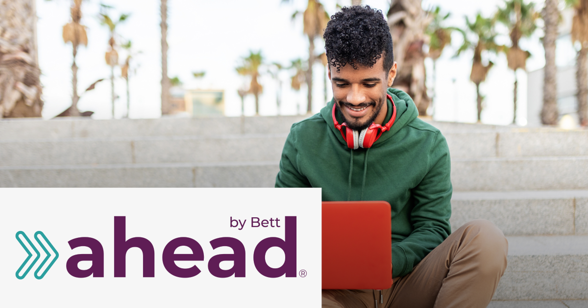 Image of a student that is checking a laptop. On the lower left corner is placed the By Bett ahead logo. 