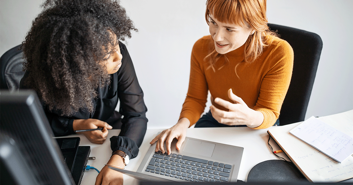 Coworkers collaborating on a laptop