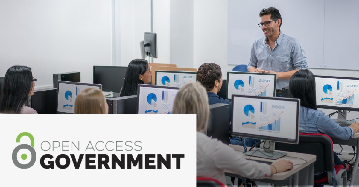 Image with the Open Access Government logo on the lower left corner and a picture of a teacher talking to his students in a classroom