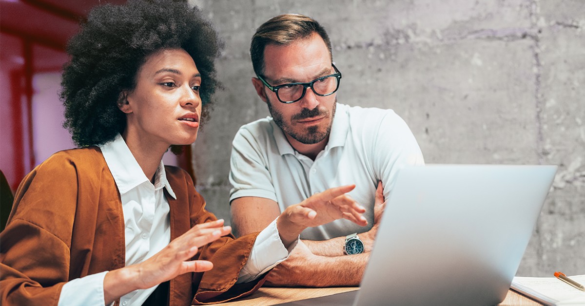 two people collaborating together on a laptop