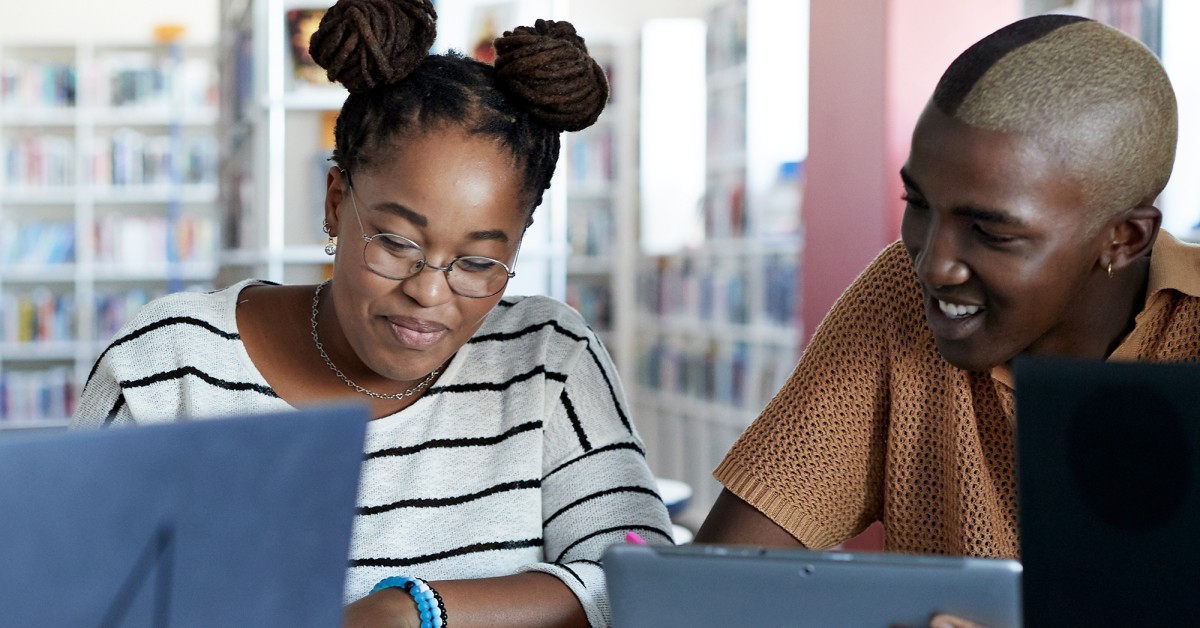 two people collaborating together in a library setting