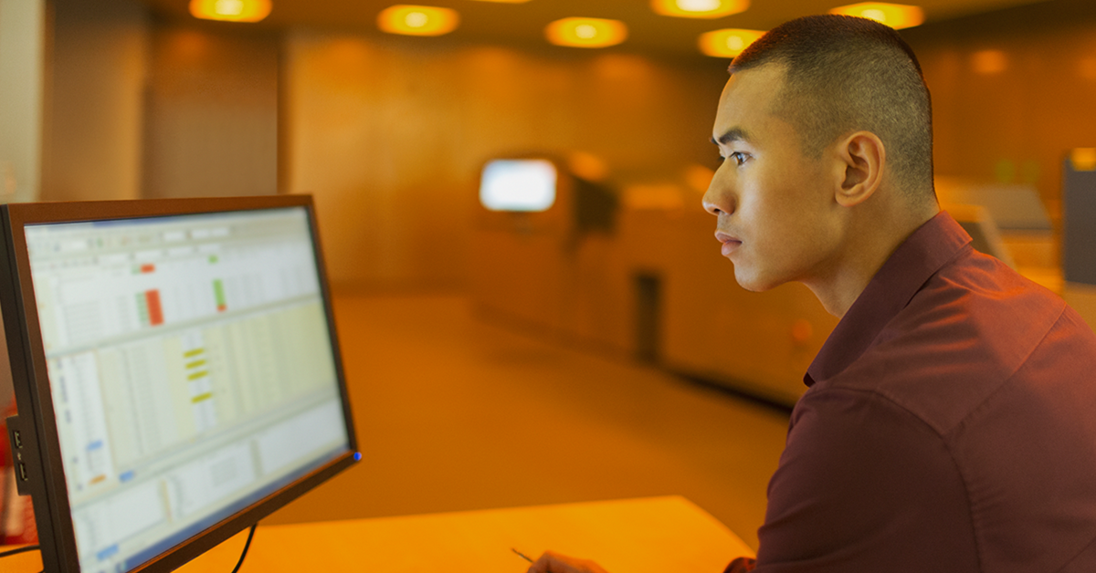 man working on a computer in an office setting