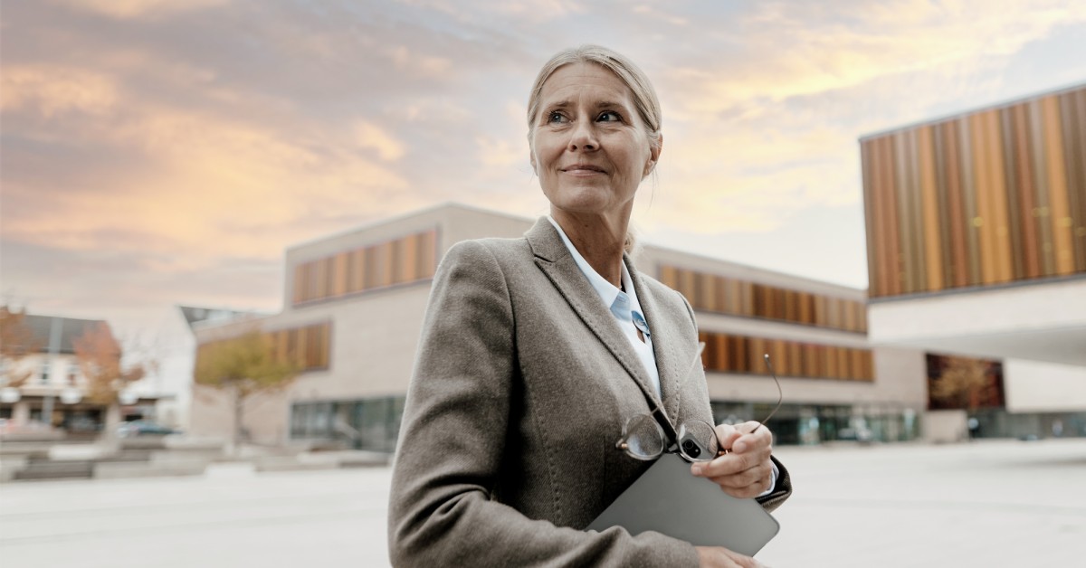 woman in a suit with a campus background