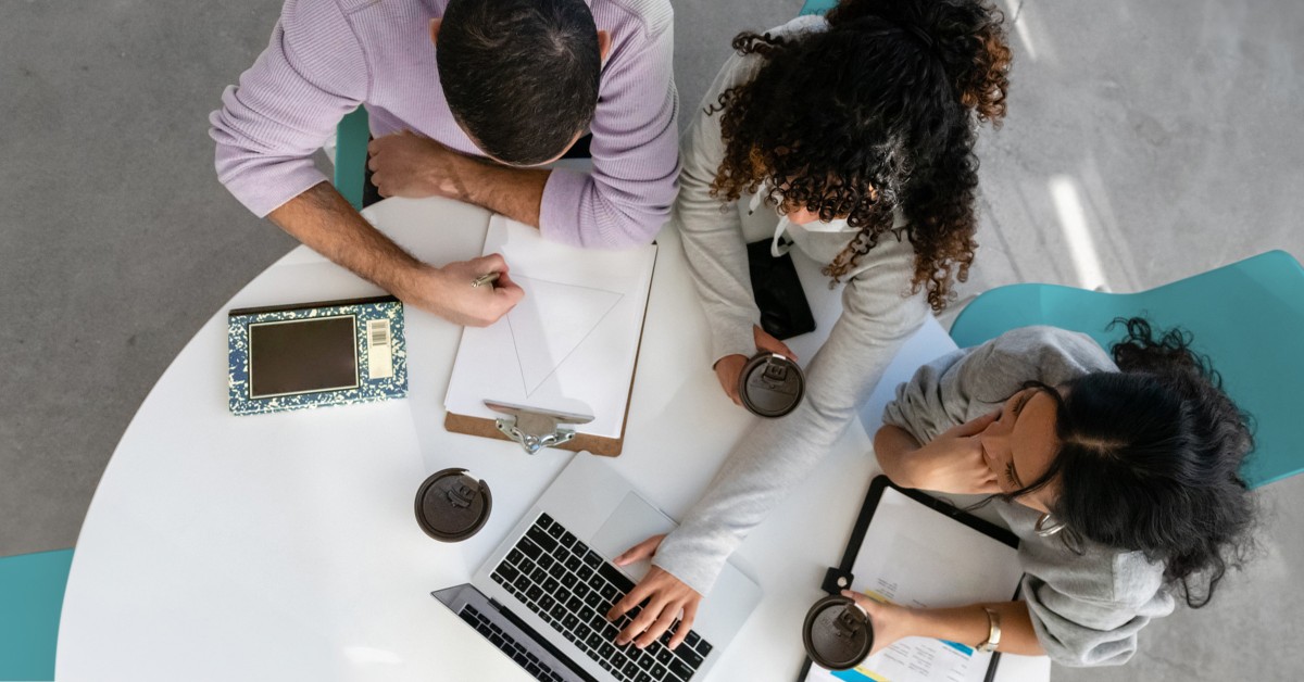 Overhead photo of three people working at a table