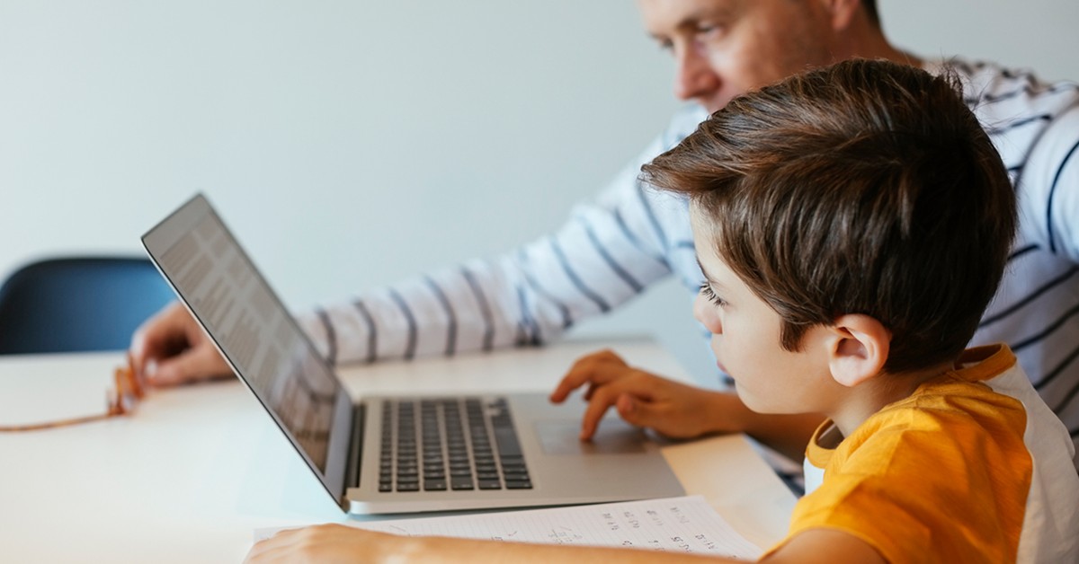 A father and son working on a laptop