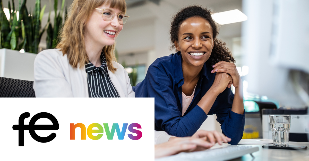 Two women smiling and looking at a computer screen in an office. "fe news" logo in the bottom left corner.