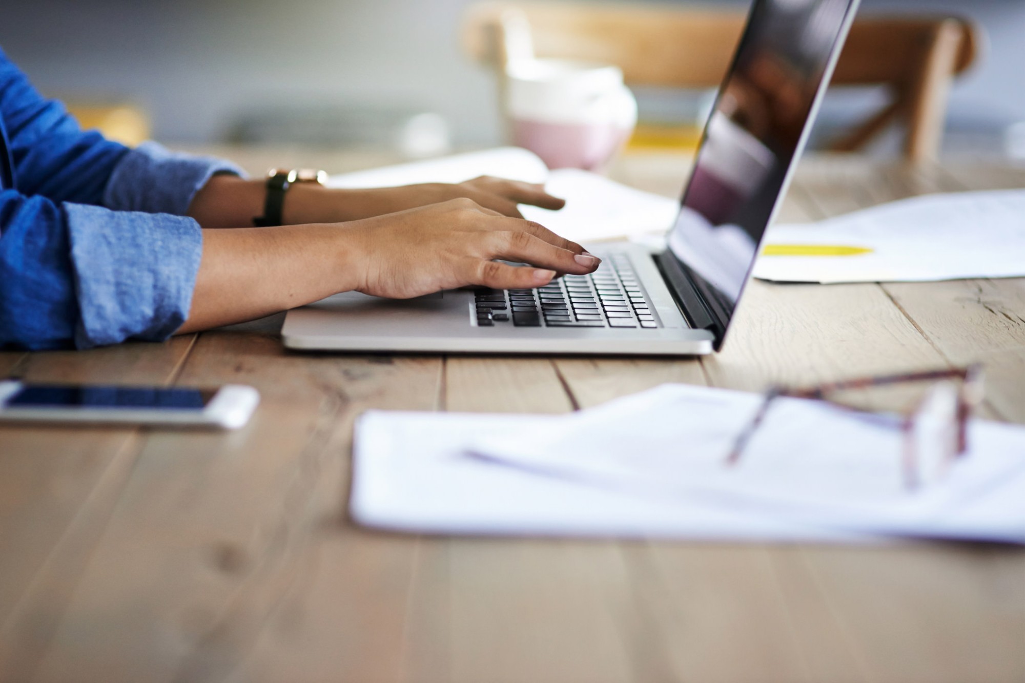 Photo of a person working on a laptop