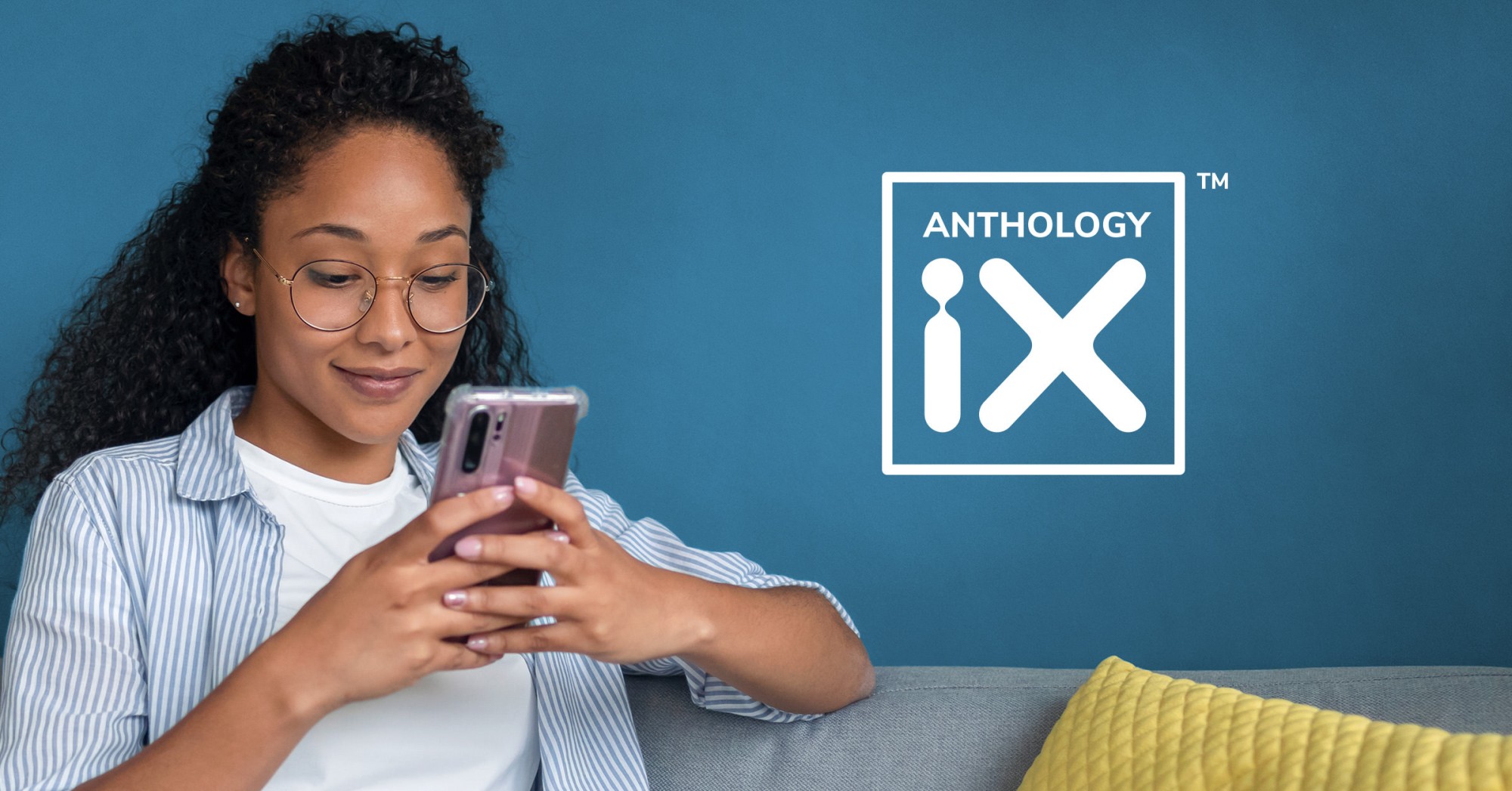 Photo of a person working on their phone with the Anthology iX logo overlayed