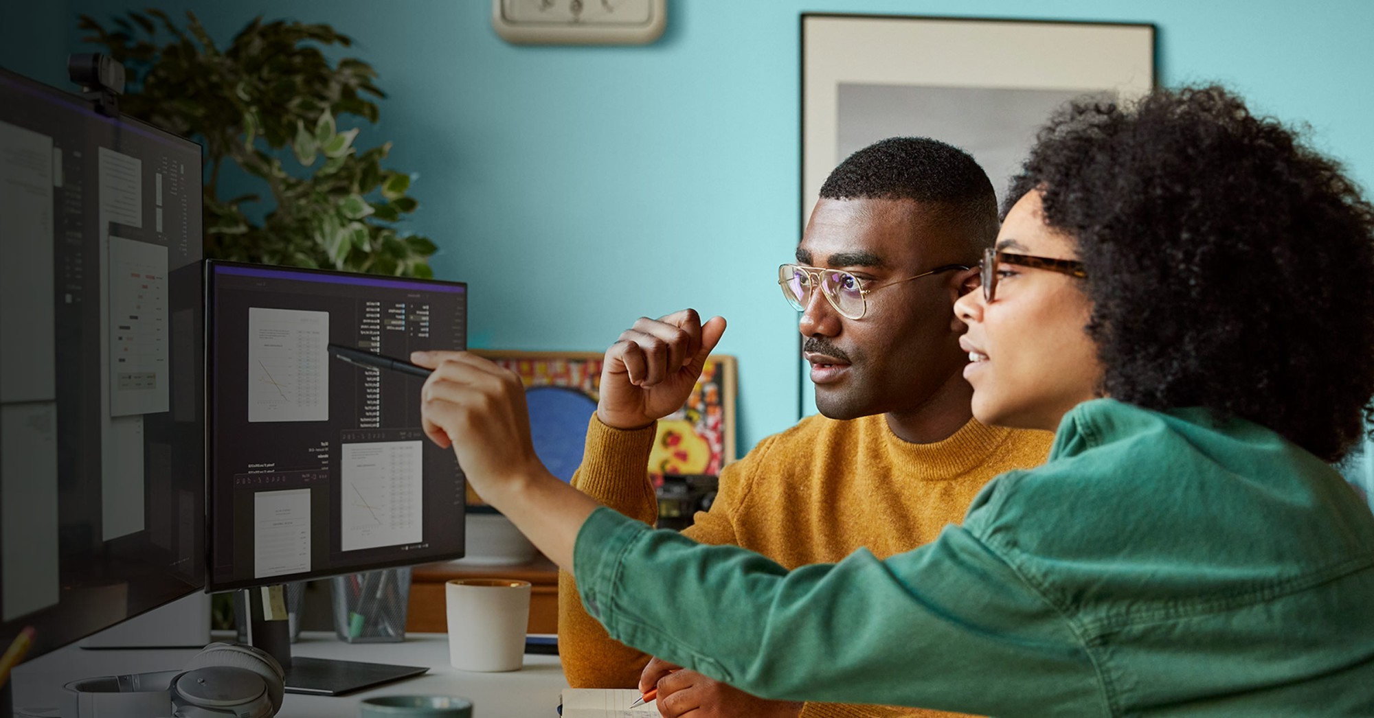 Photo of two people working at a computer