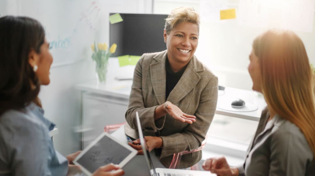 Photo of three women collaborating