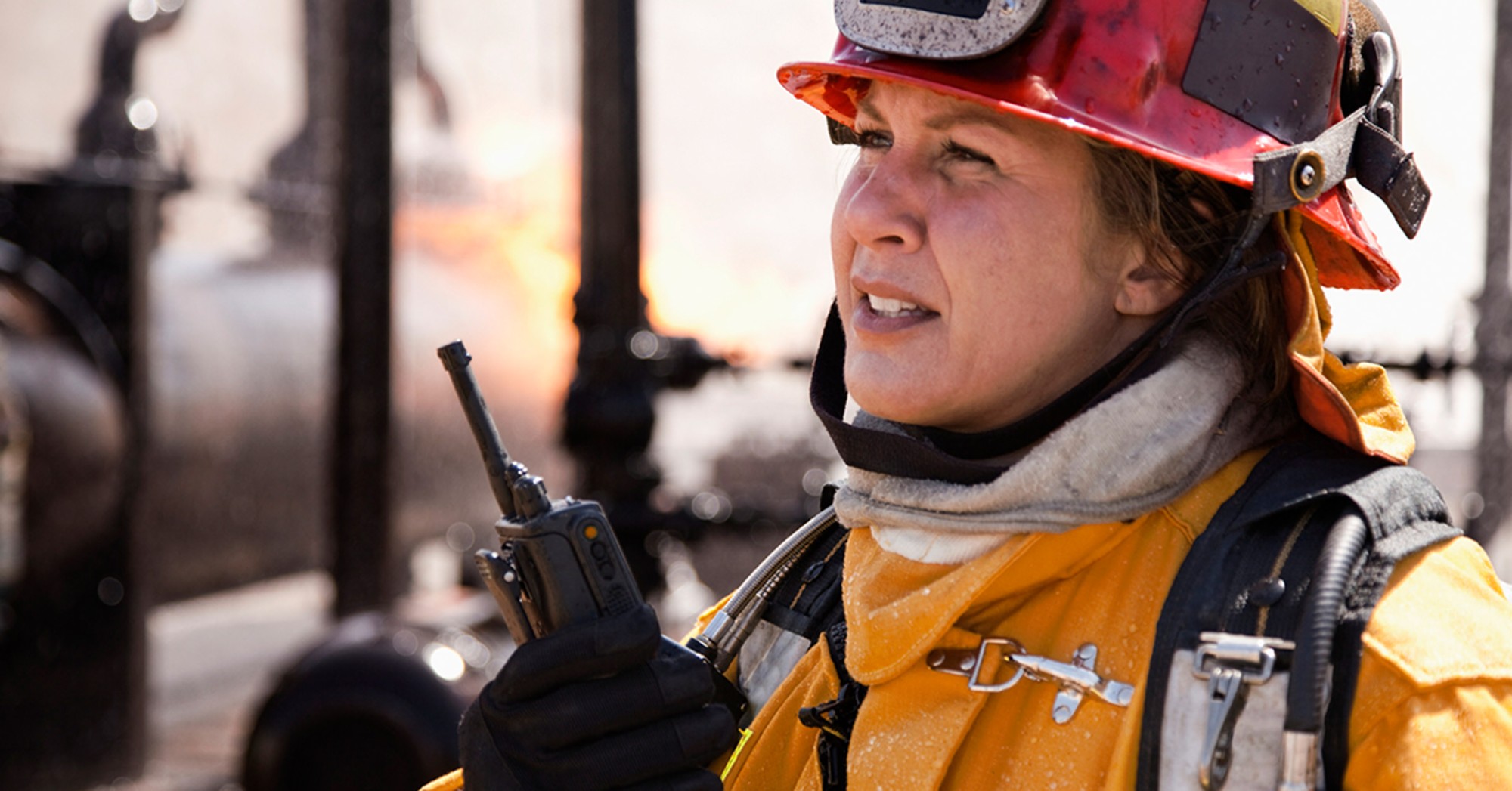 Firefighter holding her walkie-talkie