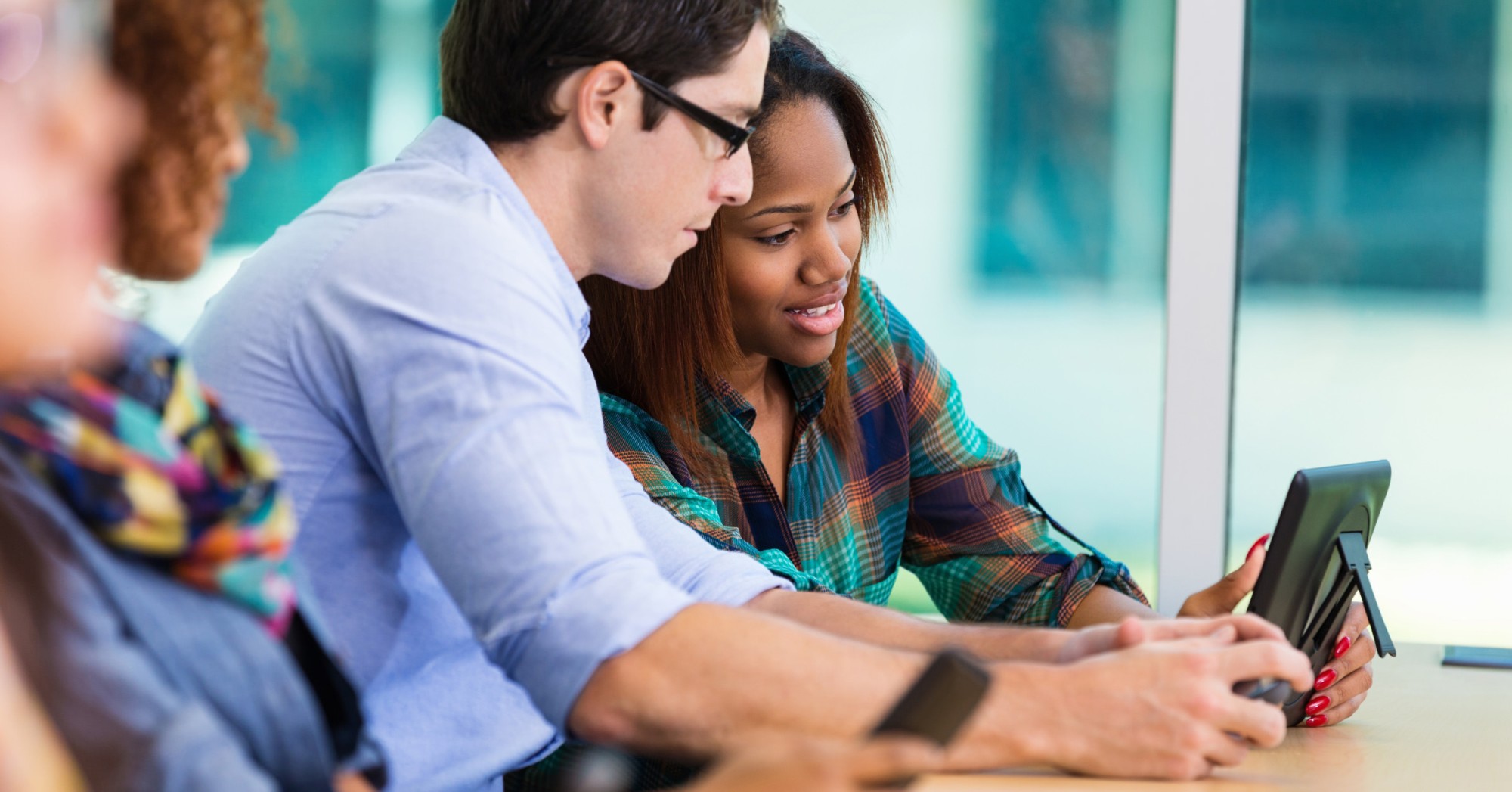 Photo of two people watching a webinar on a tablet