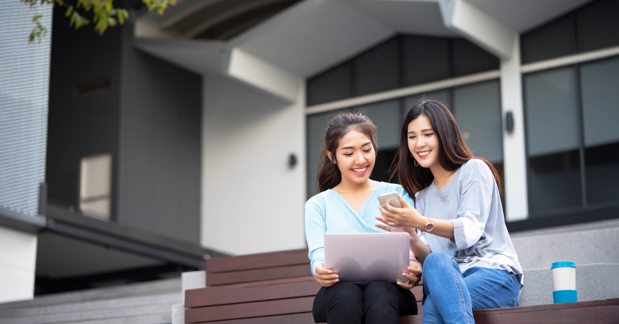 Two students looking at a phone together