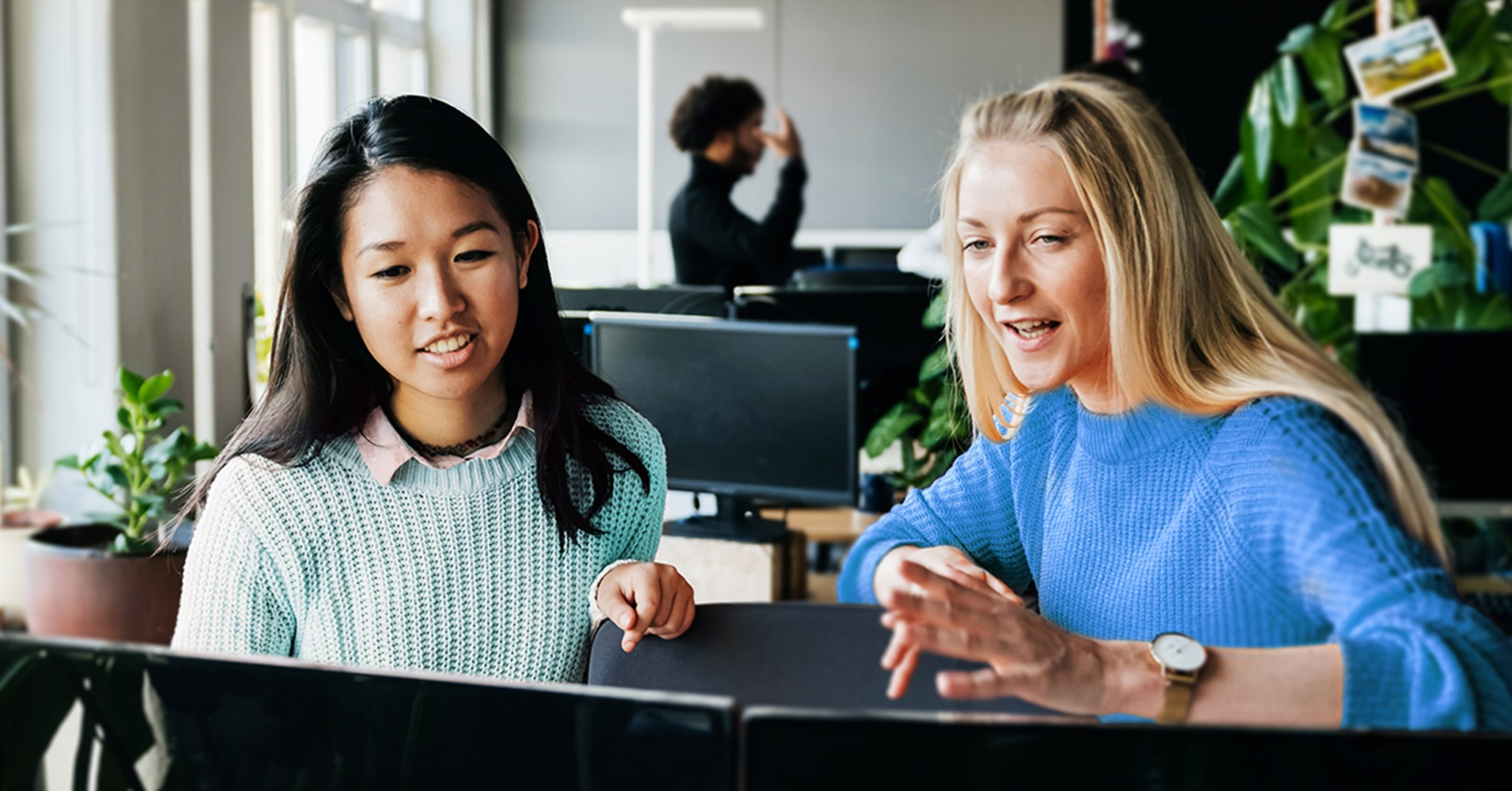 Two students looking at a computer together