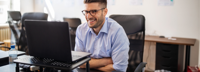 Photo of a man in a meeting on his laptop