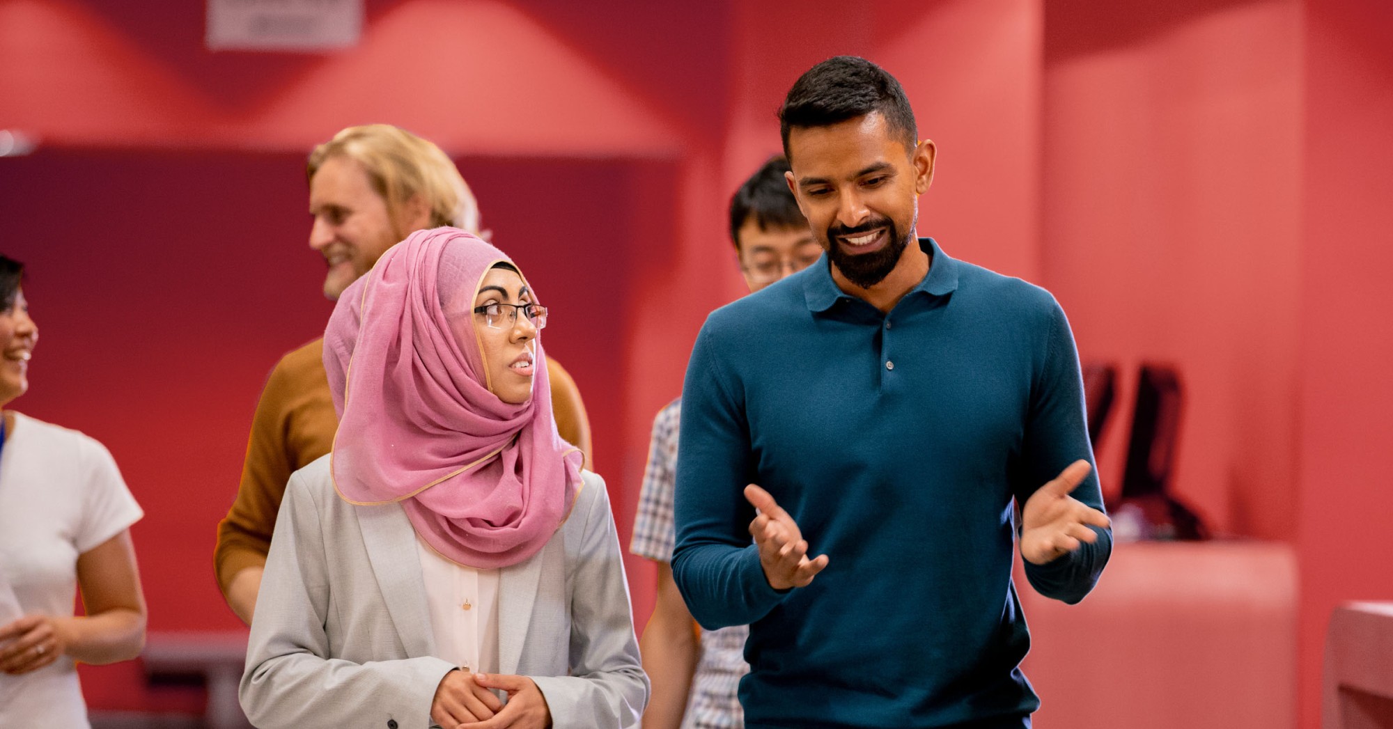 Photo of two people walking and talking