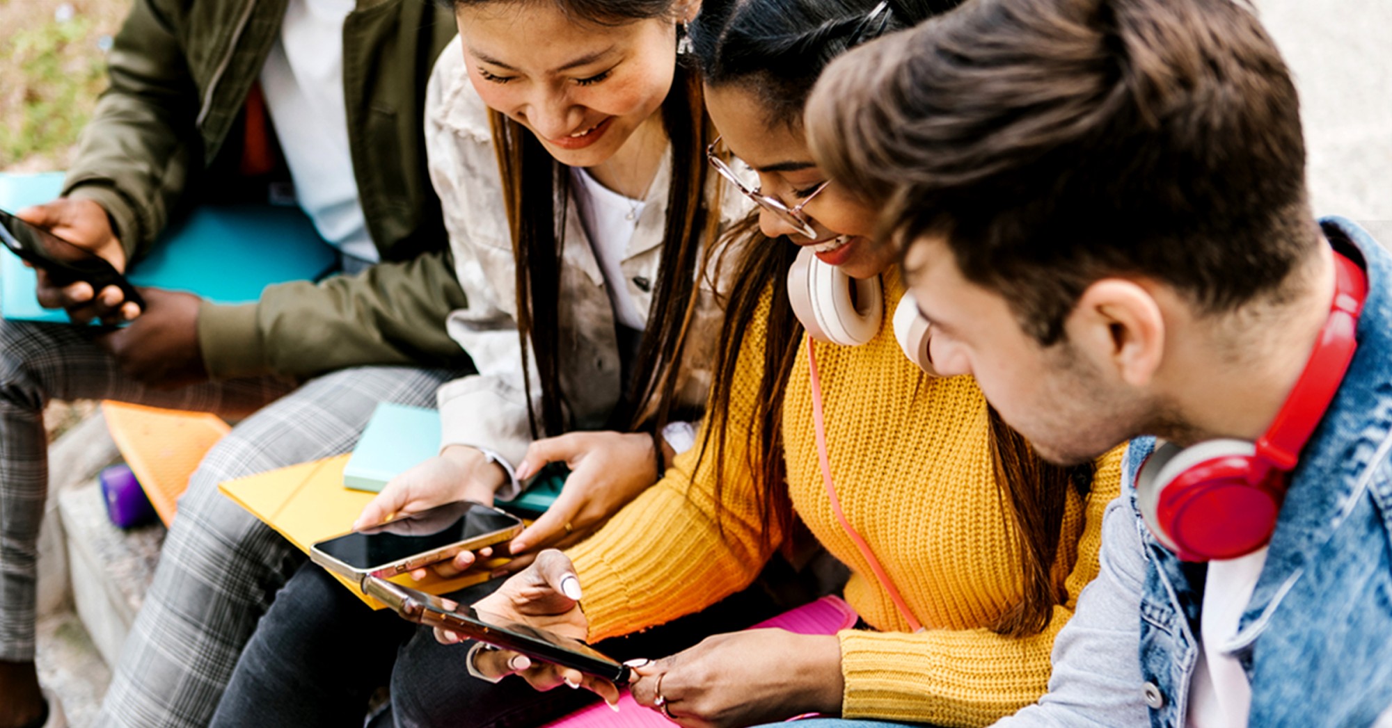 Students looking at their phones together