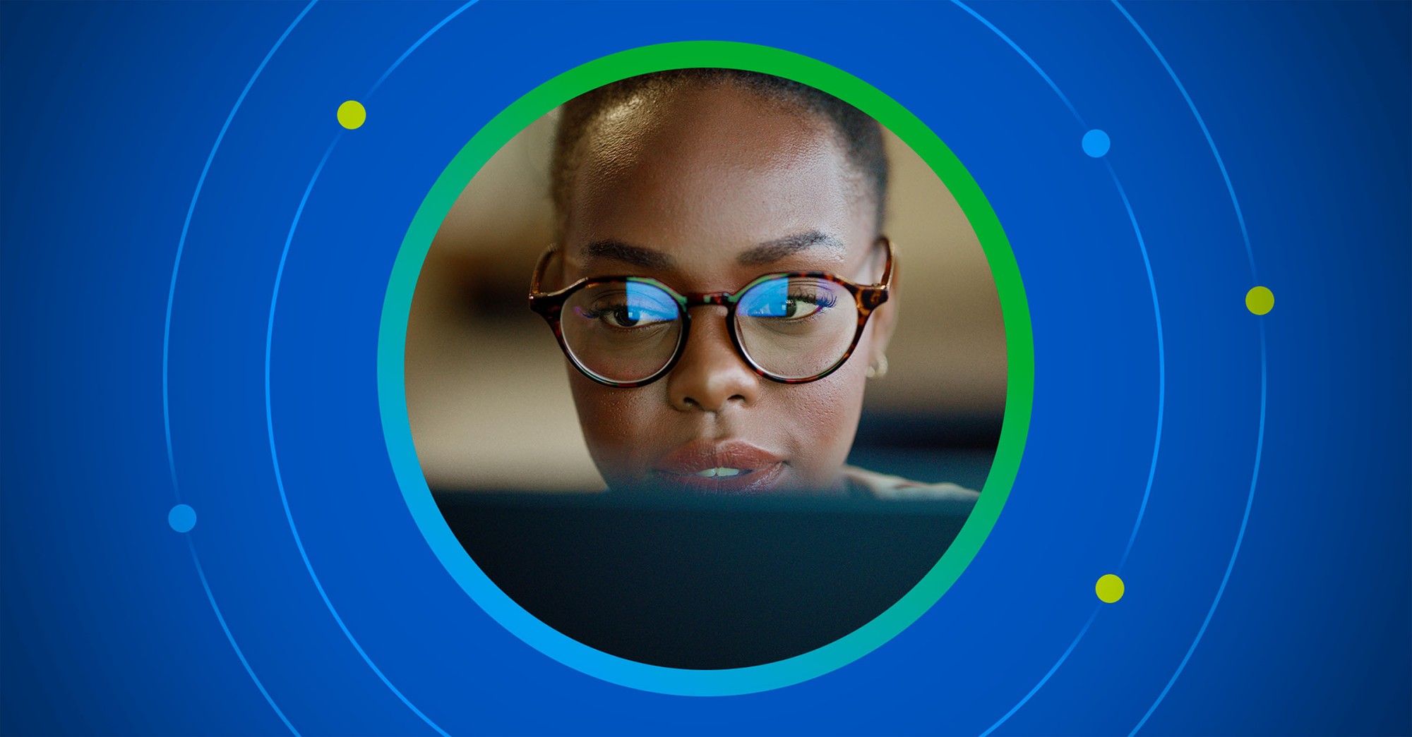 Stylized photo of a woman working at a laptop bringing the focus on her face