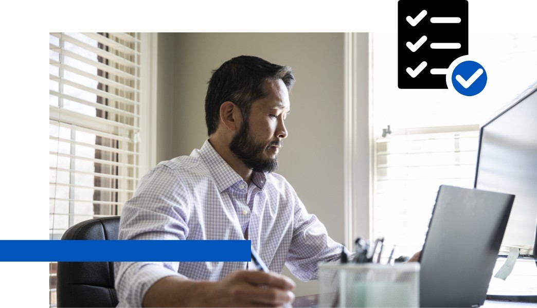 Photo of a man working at a laptop