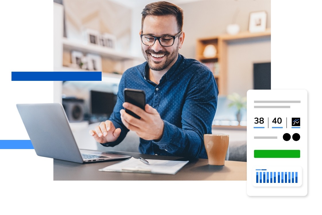Photo of a man looking at his phone while working at a laptop with an overlay of data from Raise