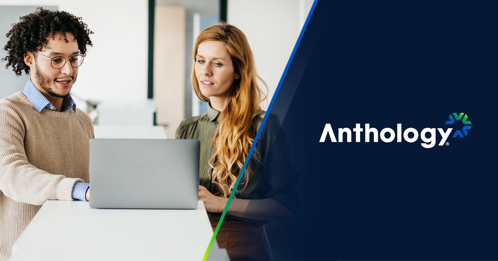 A man and woman looking at a laptop in an office setting, beside the Anthology logo.