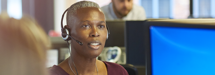 Woman using headset to access her classes online.
