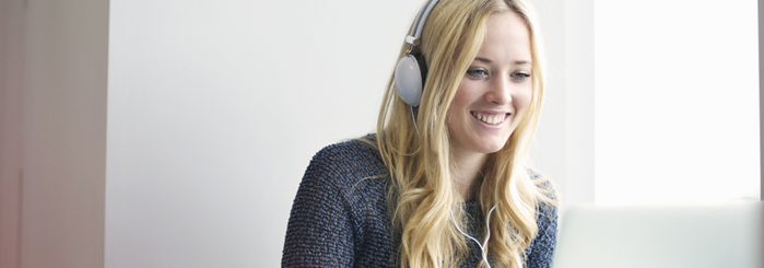 Person with headphones on attending webinar.