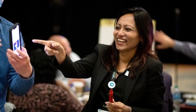 Woman smiling at a conference