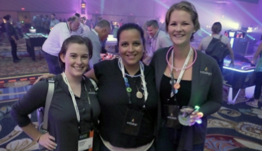 Three women posing at a conference